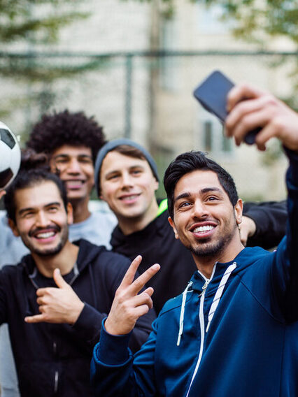 Smiling players taking selfie through mobile phone