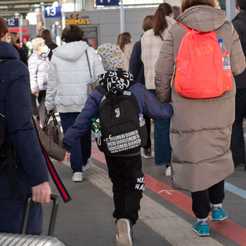 Geflüchtete kommen mit Koffern am Bahnhof an